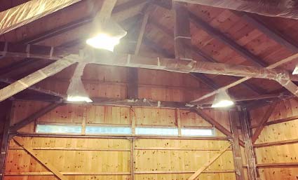 Installation of vapor barrier inside the barn in Maine.